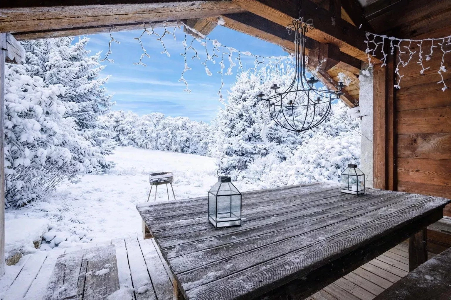 Verschneite Holzterrasse mit Alpenblick