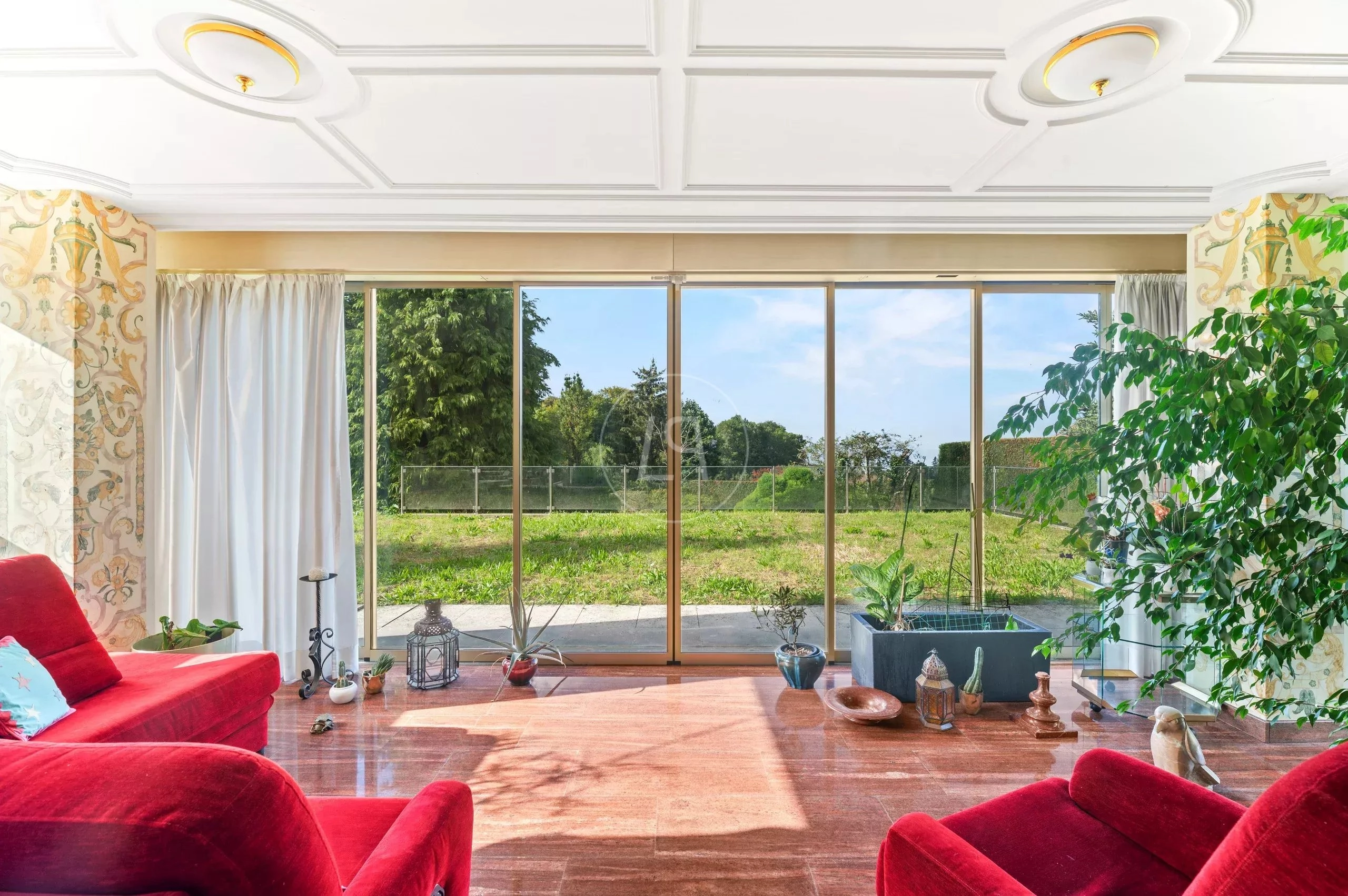Helles Wohnzimmer mit Panoramafenster zum Garten