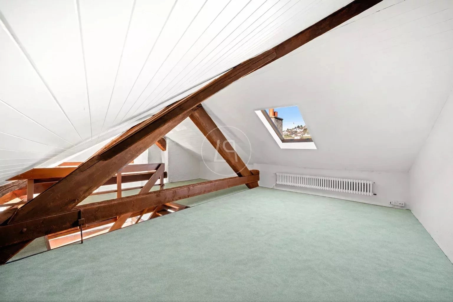 Dachgeschossraum mit sichtbaren Holzbalken