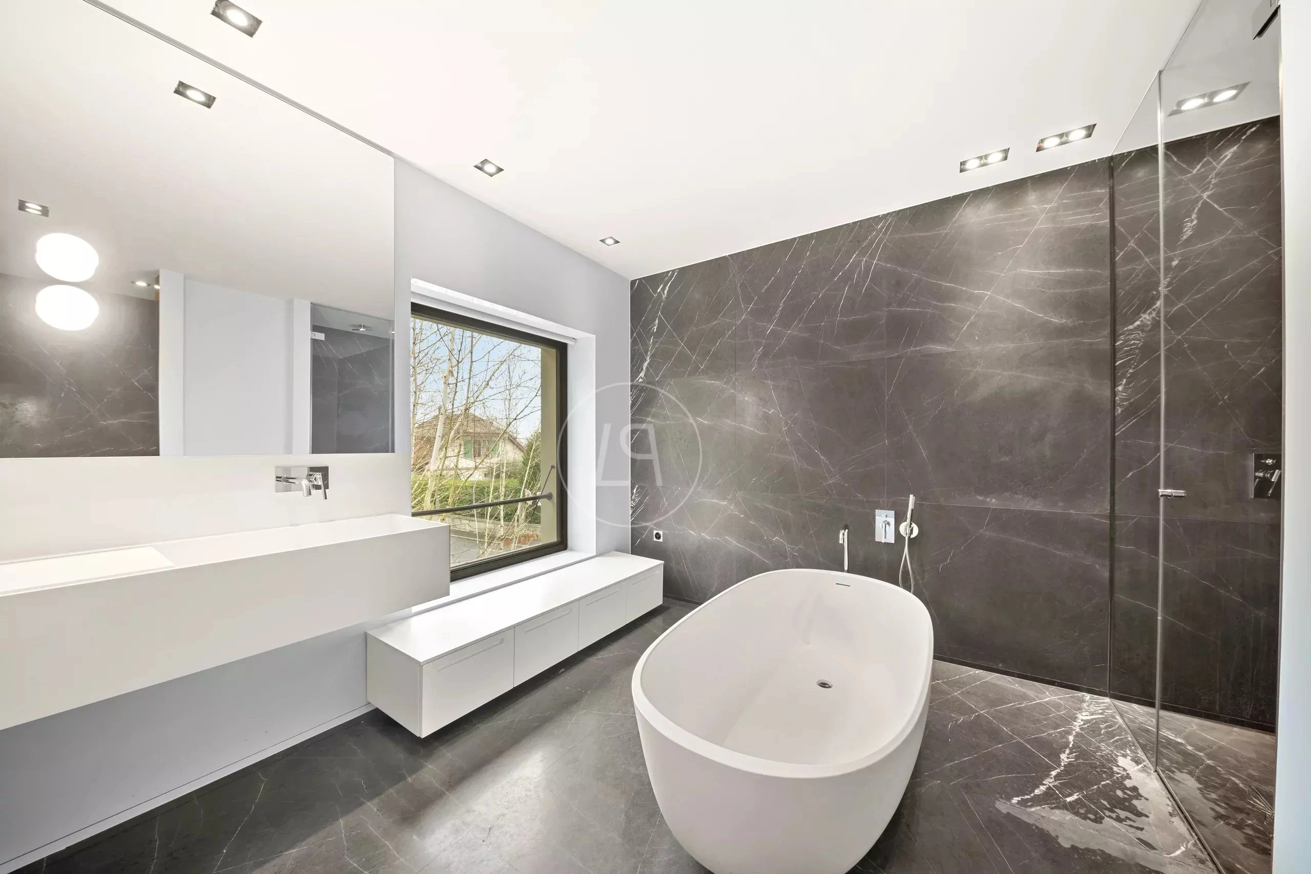 Modernes Badezimmer mit freistehender Wanne und dunkler Steinoptik