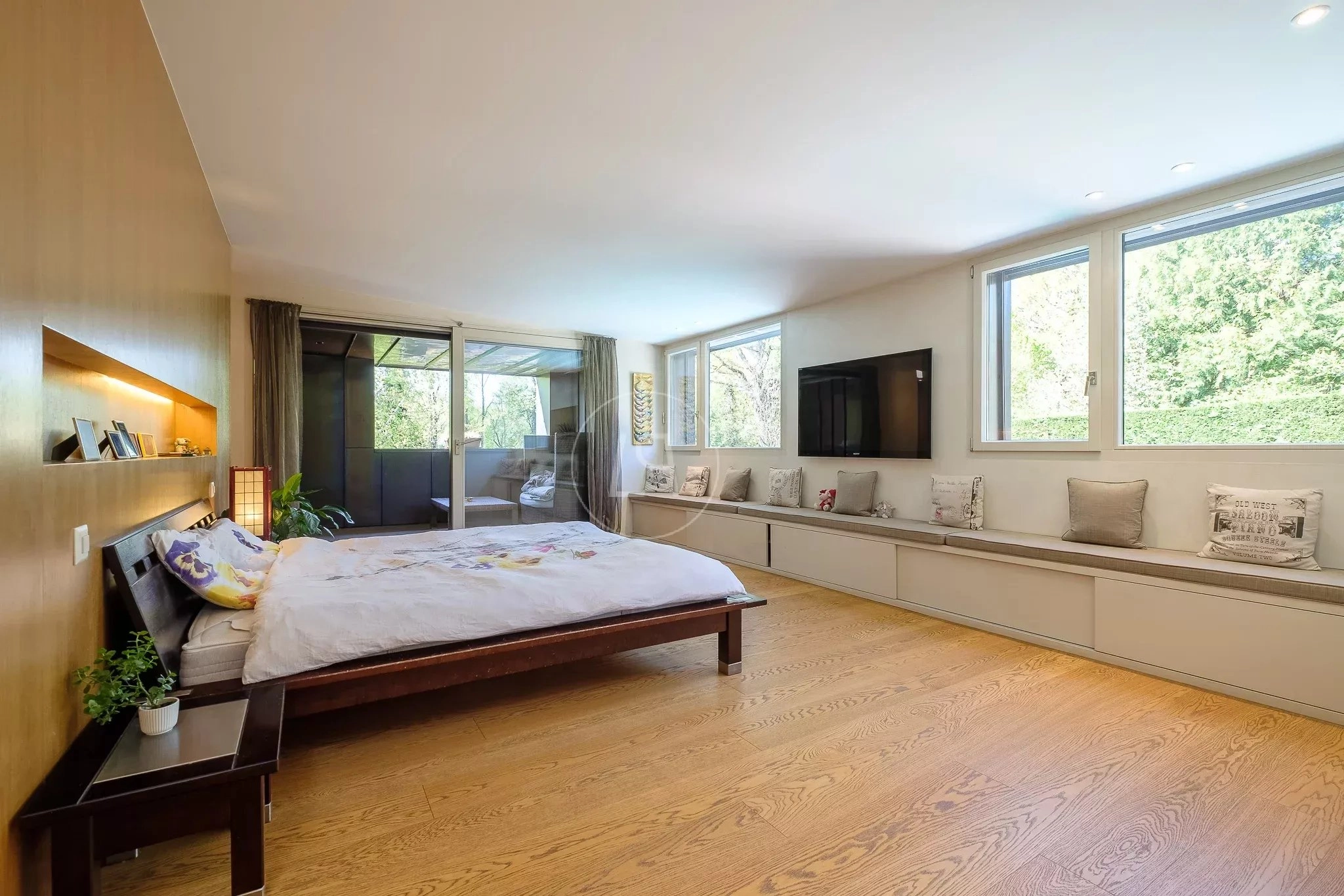 Helles Schlafzimmer mit Fensterbank und Gartenausblick