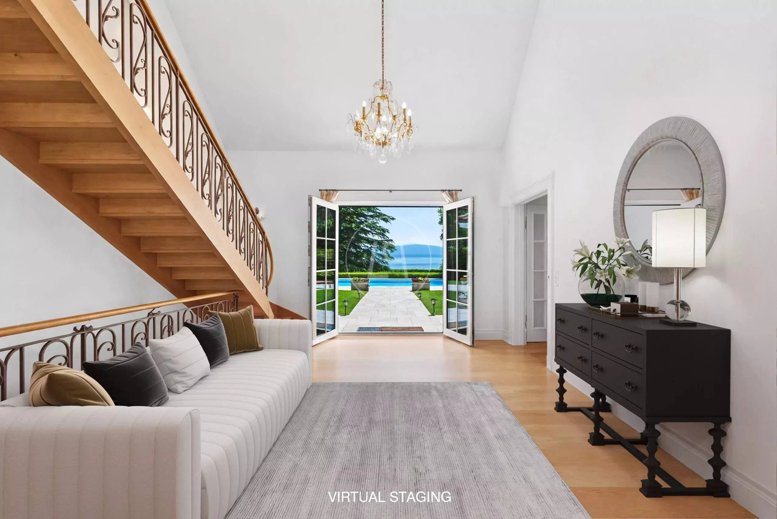 Eleganter Eingangsbereich mit Treppe und Gartenausblick