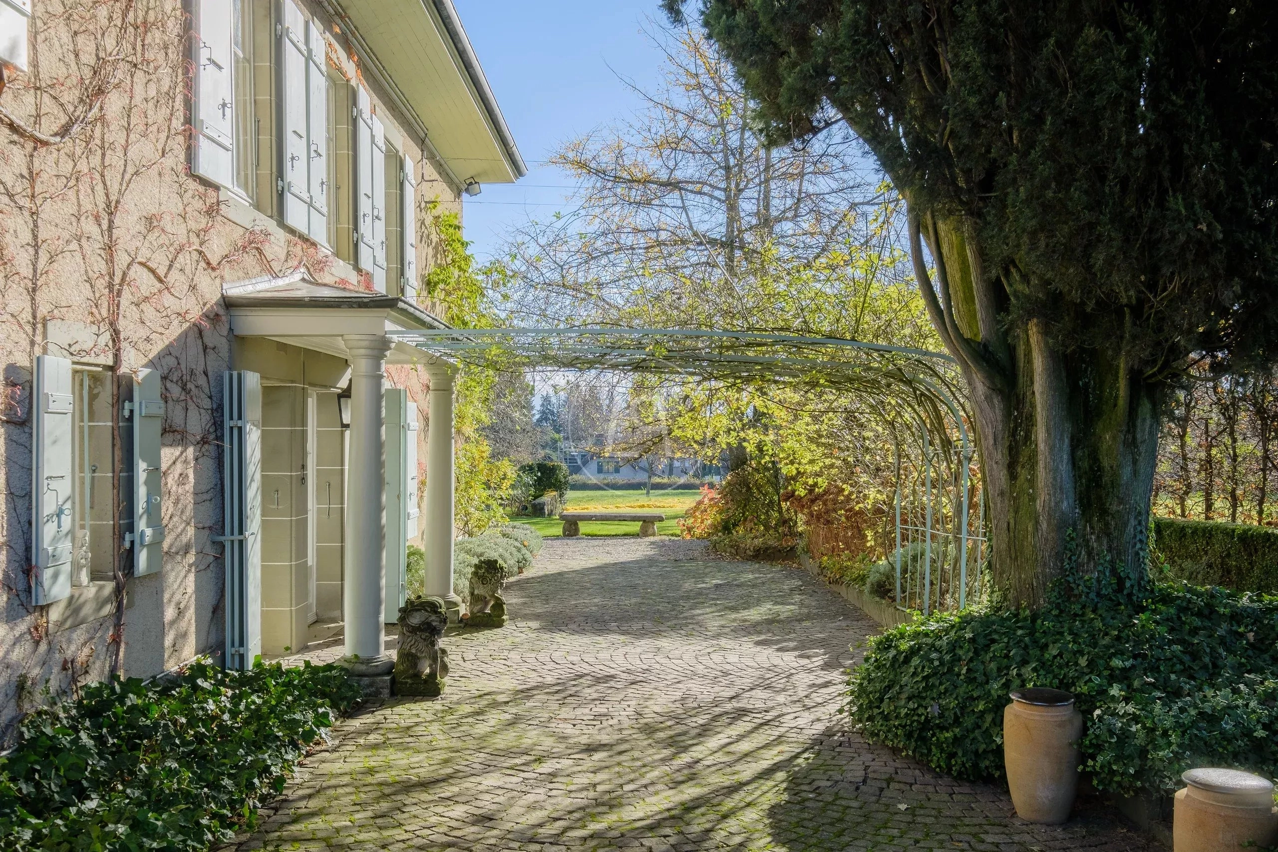Einfahrt mit Begrünung und Pergola