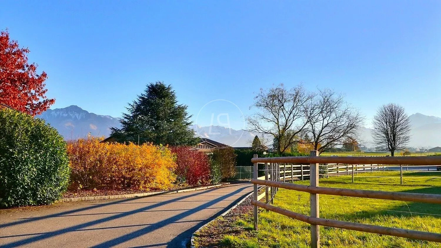 Landschaftlicher Außenbereich mit Zufahrt und Bergblick