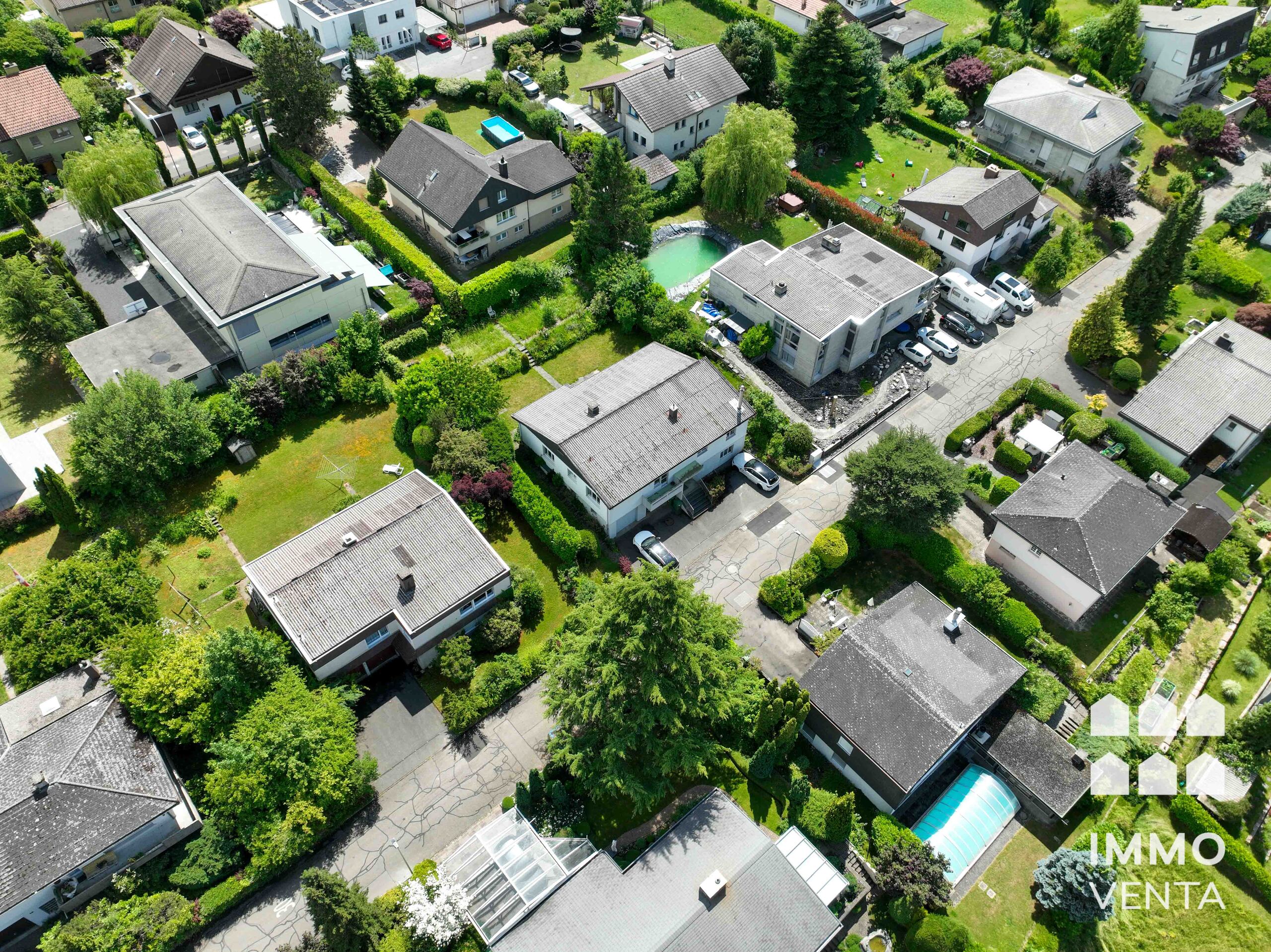 Luftaufnahme eines Wohnviertels mit Häusern, Gärten, Pools und Zufahrten