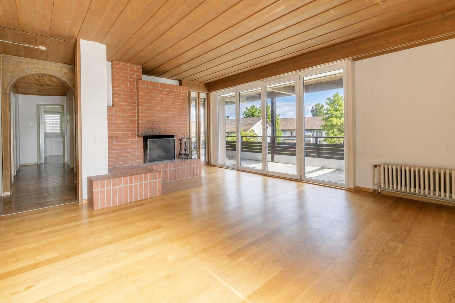 Wohnzimmer mit Kamin und Balkonzugang
