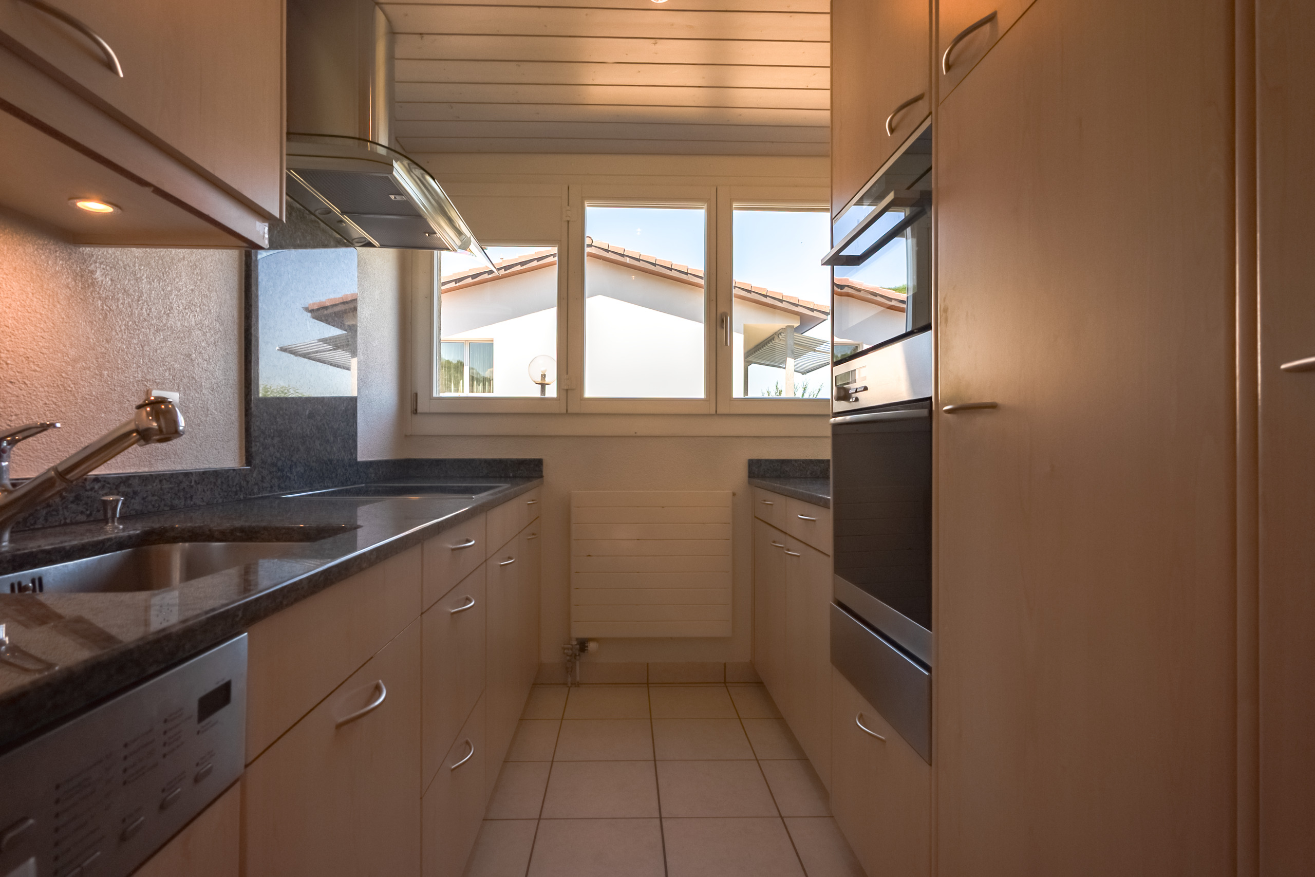 Schmale Einbauküche mit Fensterfront