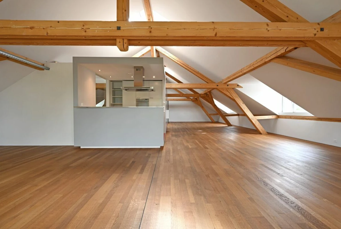 Dachgeschoss-Loft mit sichtbaren Holzbalken