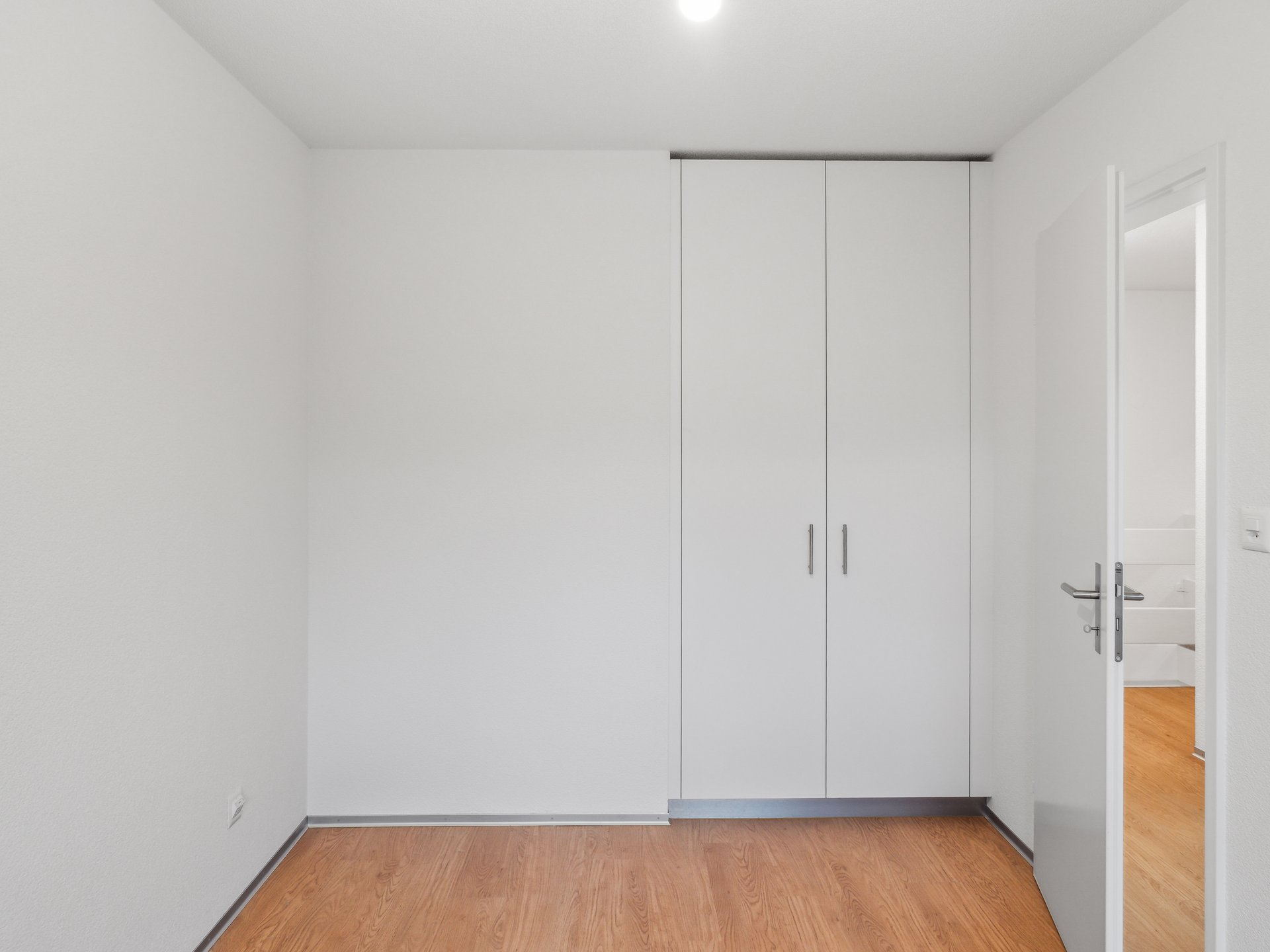 Helles, leeres Schlafzimmer mit Einbauschrank