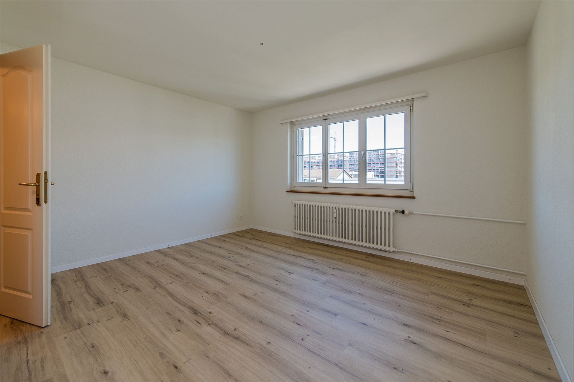 Leeres Zimmer mit Fenster und Heizkörper