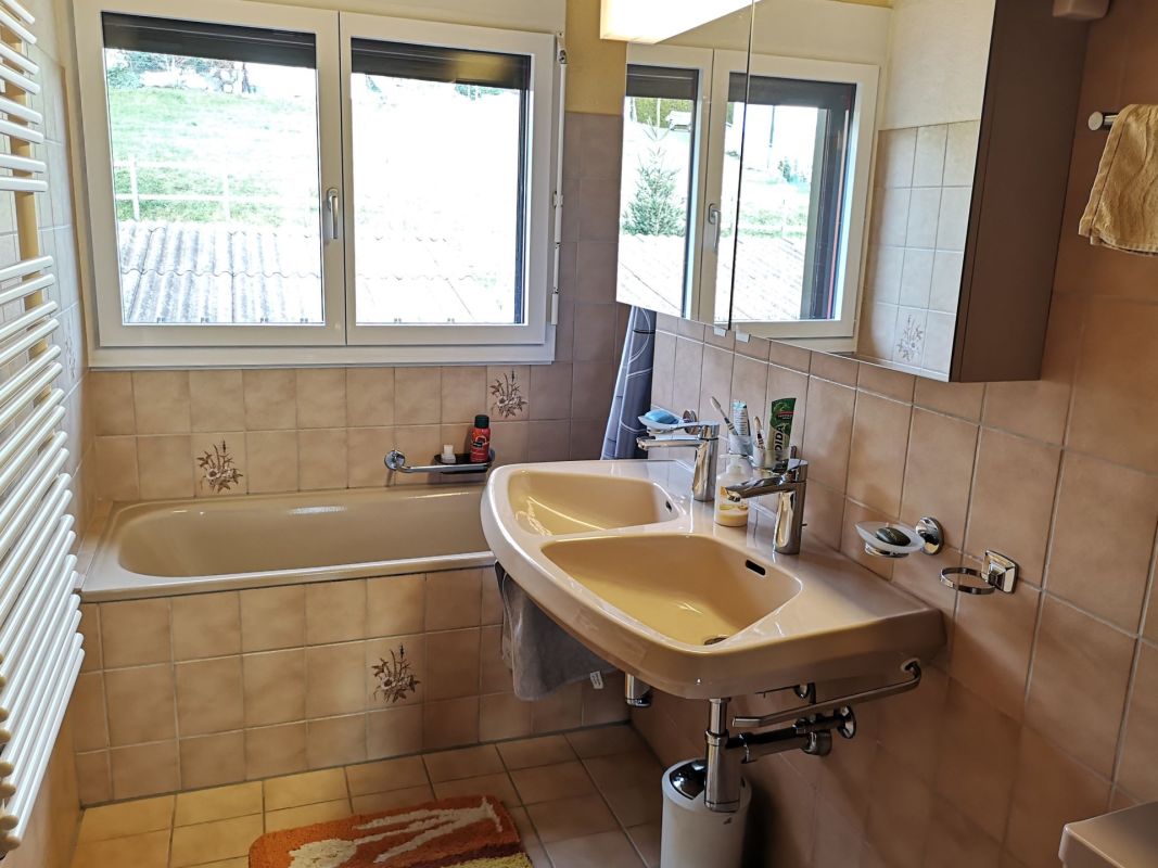 Badezimmer mit Badewanne und Doppelwaschtisch
