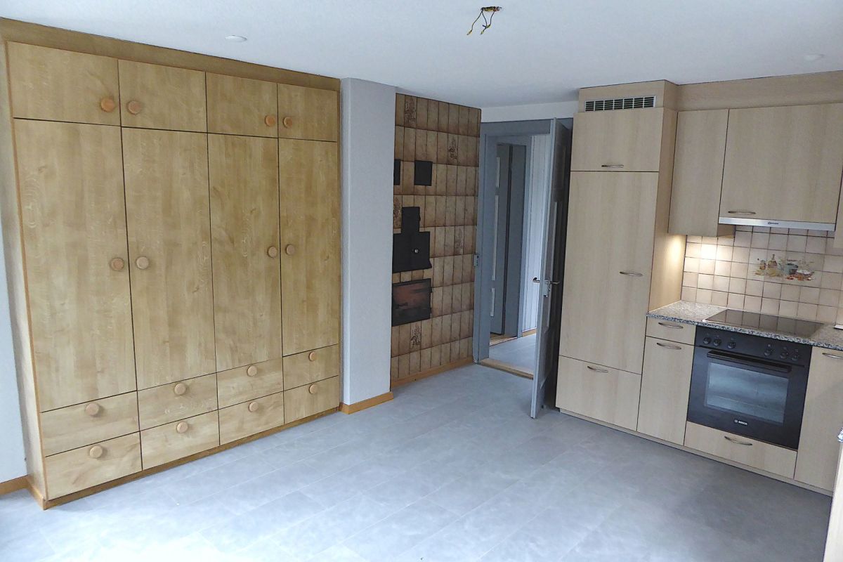 Helle Küche mit Einbauschränken und großem Wandschrank