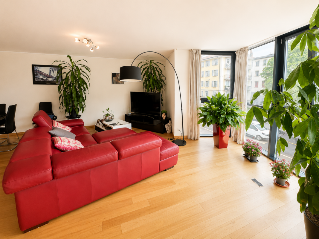 Heller Wohnraum mit rotem Ledersofa