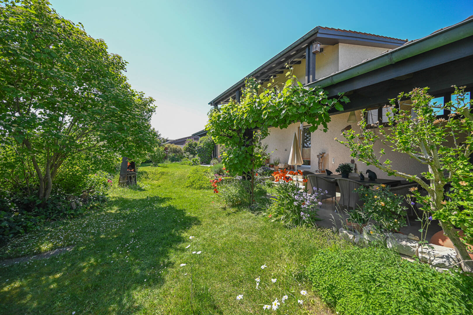Gartenansicht eines Wohnhauses mit Terrasse