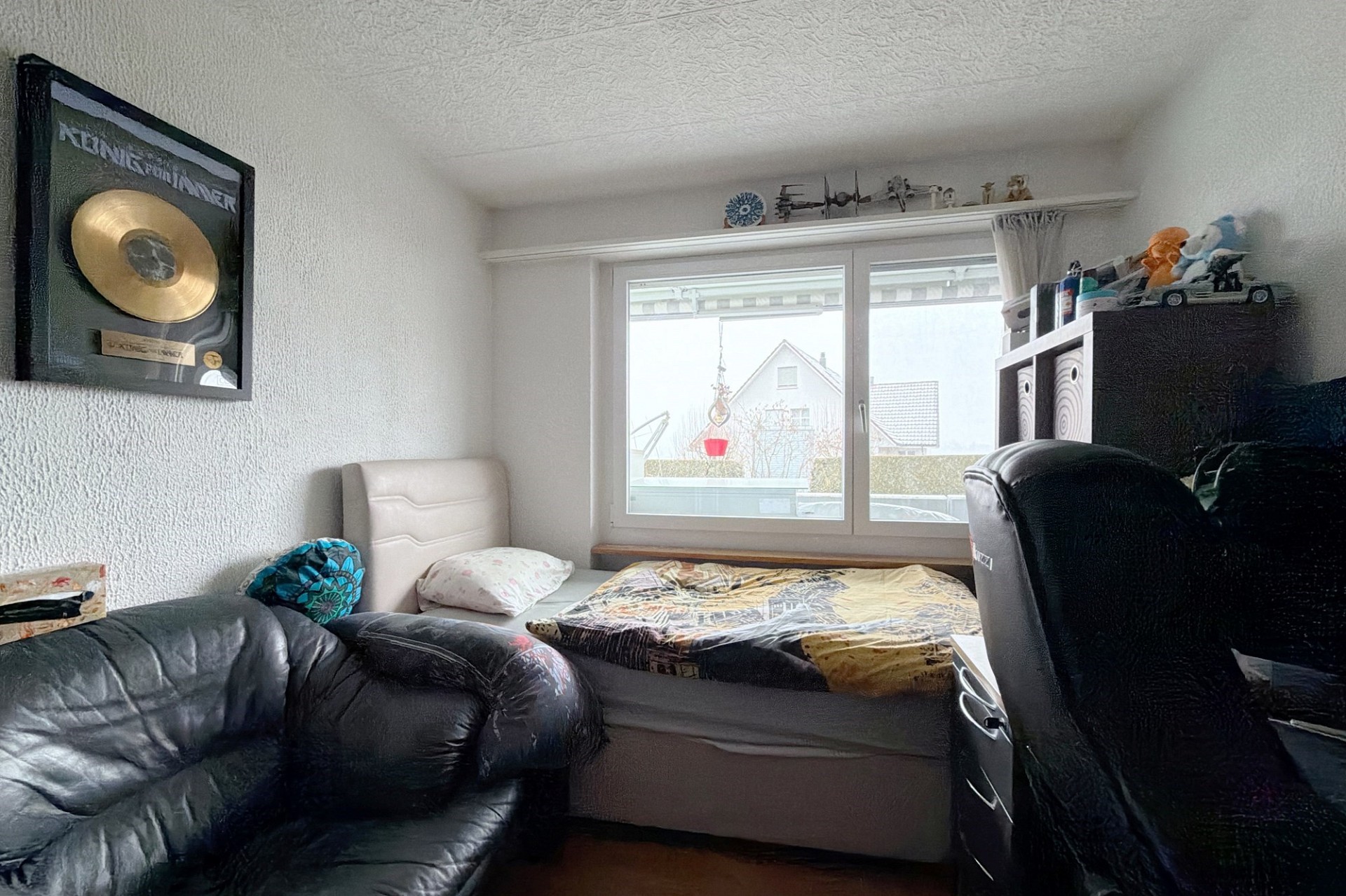 Kleines Schlafzimmer mit Bett am Fenster