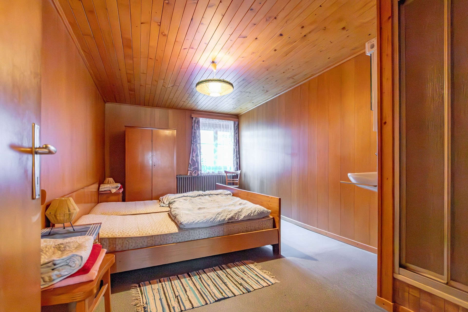 Schlafzimmer mit Holzvertäfelung