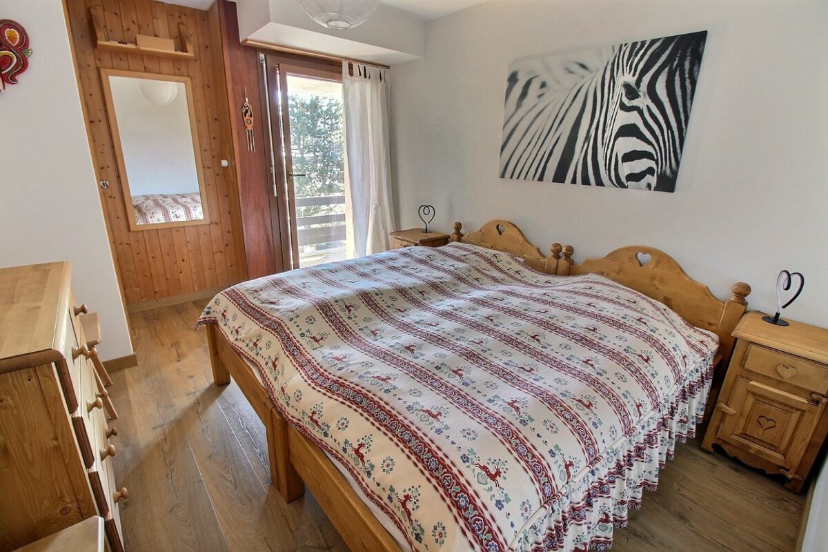 Schlafzimmer mit Holzmöbeln und Balkonzugang