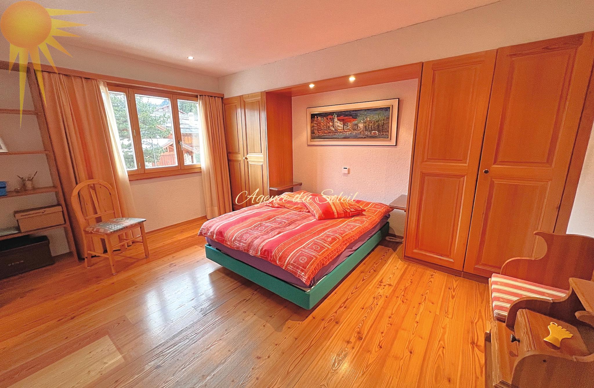 Gemütliches Schlafzimmer mit Holzmöbeln und warmem Tageslicht