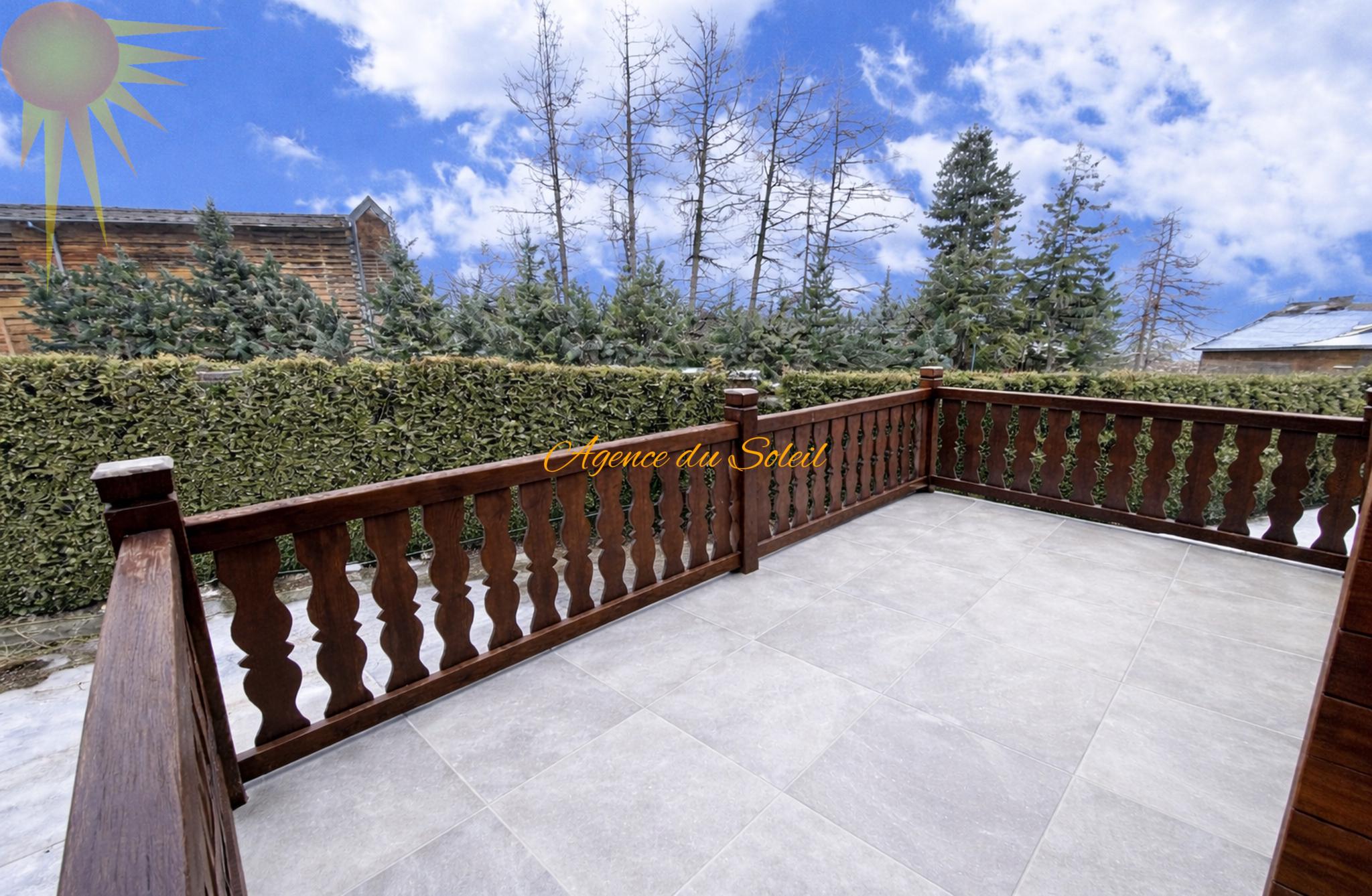 Terrasse mit Holzgeländer und Blick ins Grüne