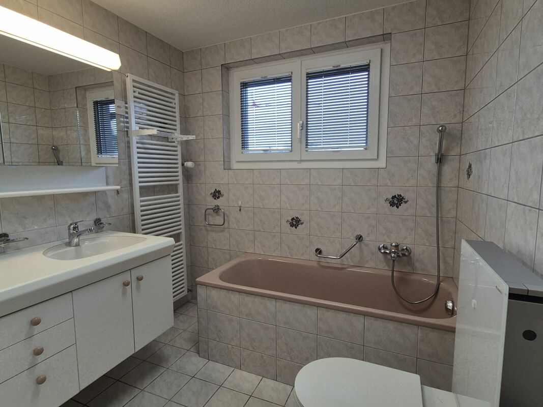 Badezimmer mit Wanne und Waschtisch