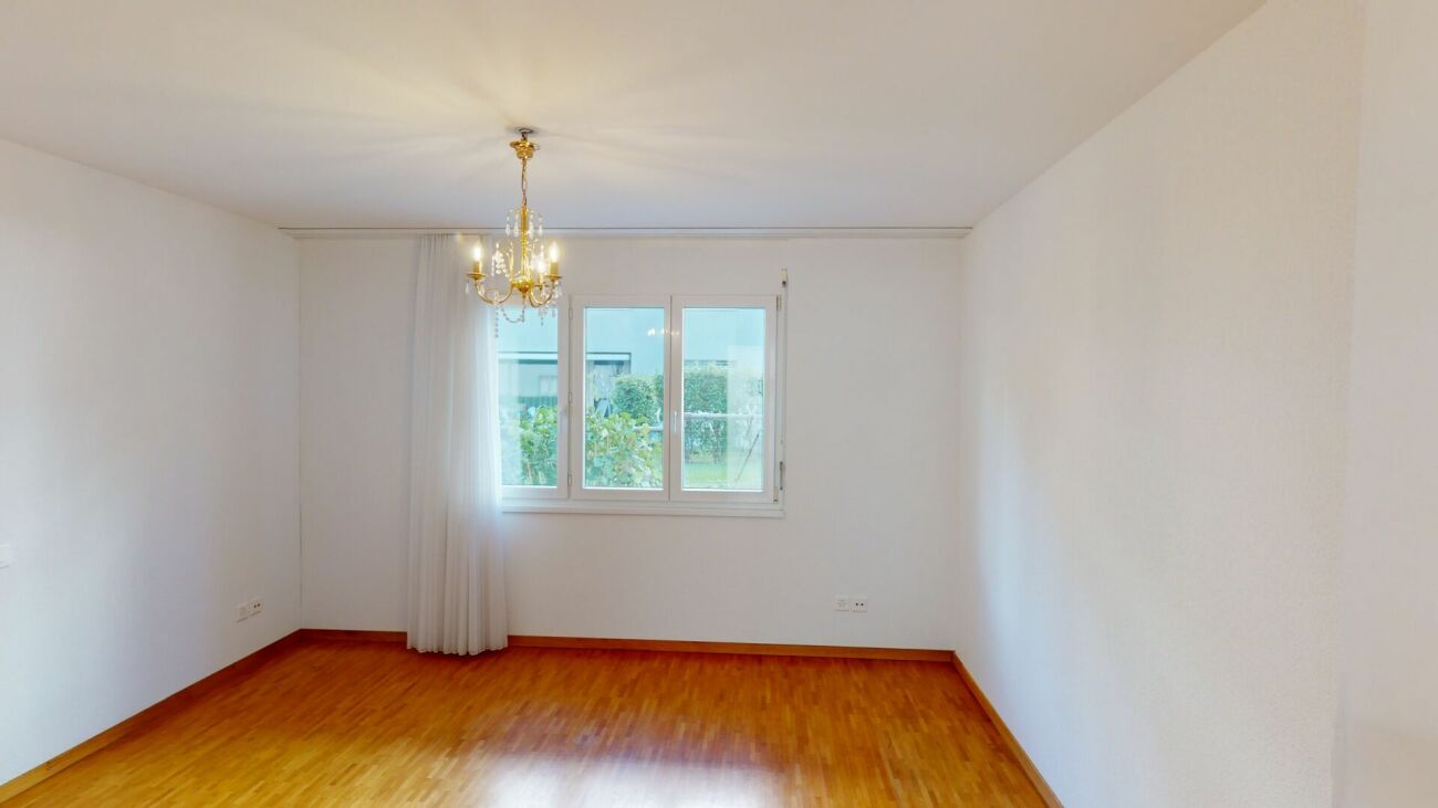 Leerer Wohnraum mit Parkett und Kronleuchter