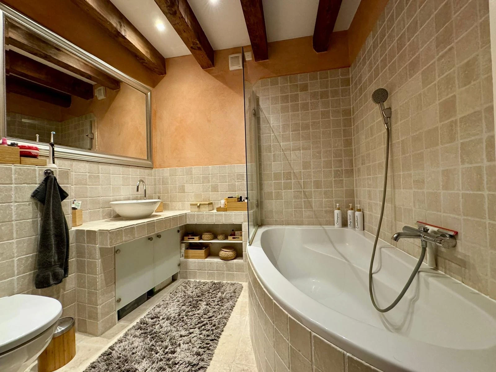 Modernes Badezimmer mit Badewanne und Natursteinoptik