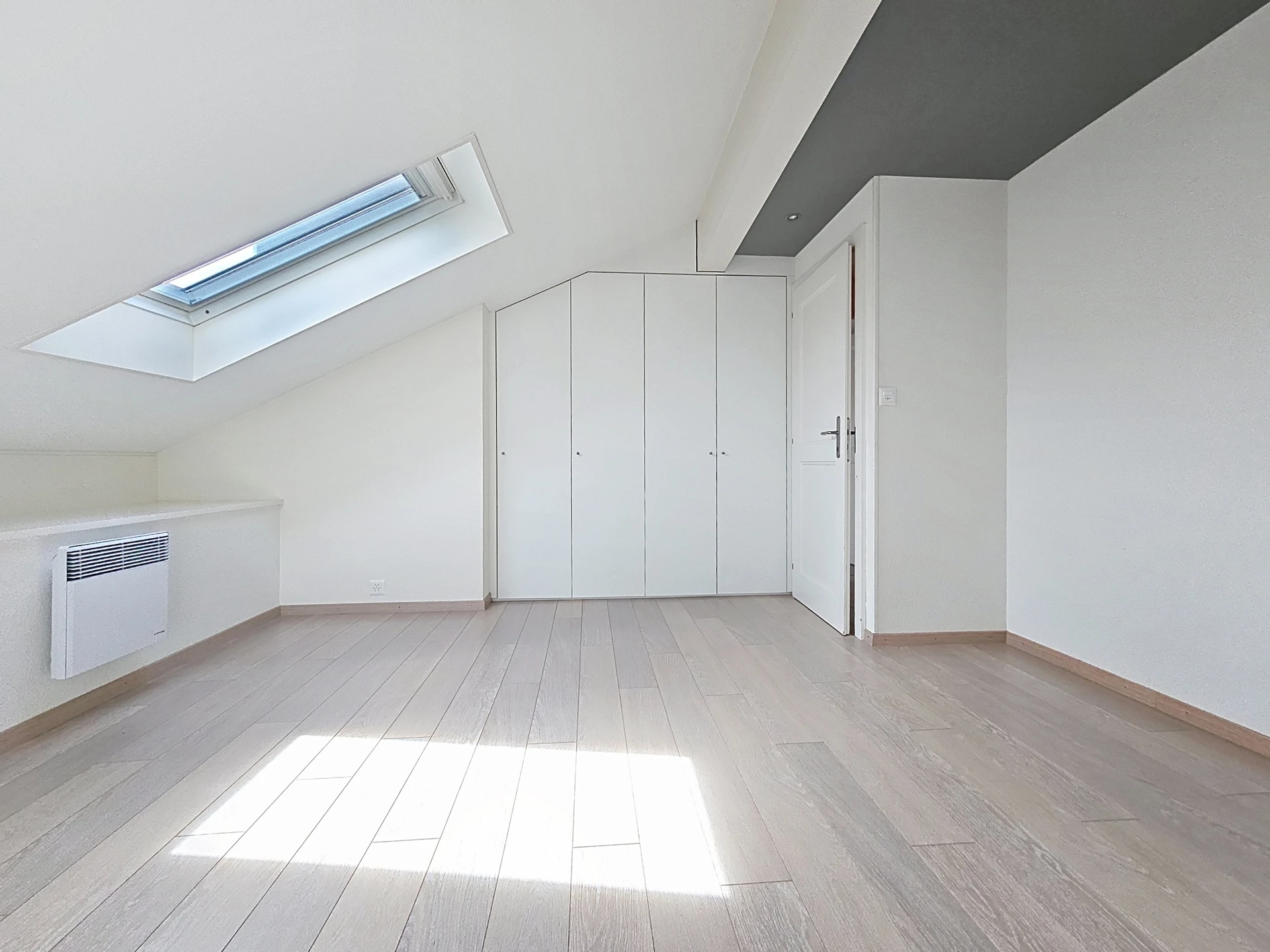 Helles Dachzimmer mit Dachfenster und Einbauschrank