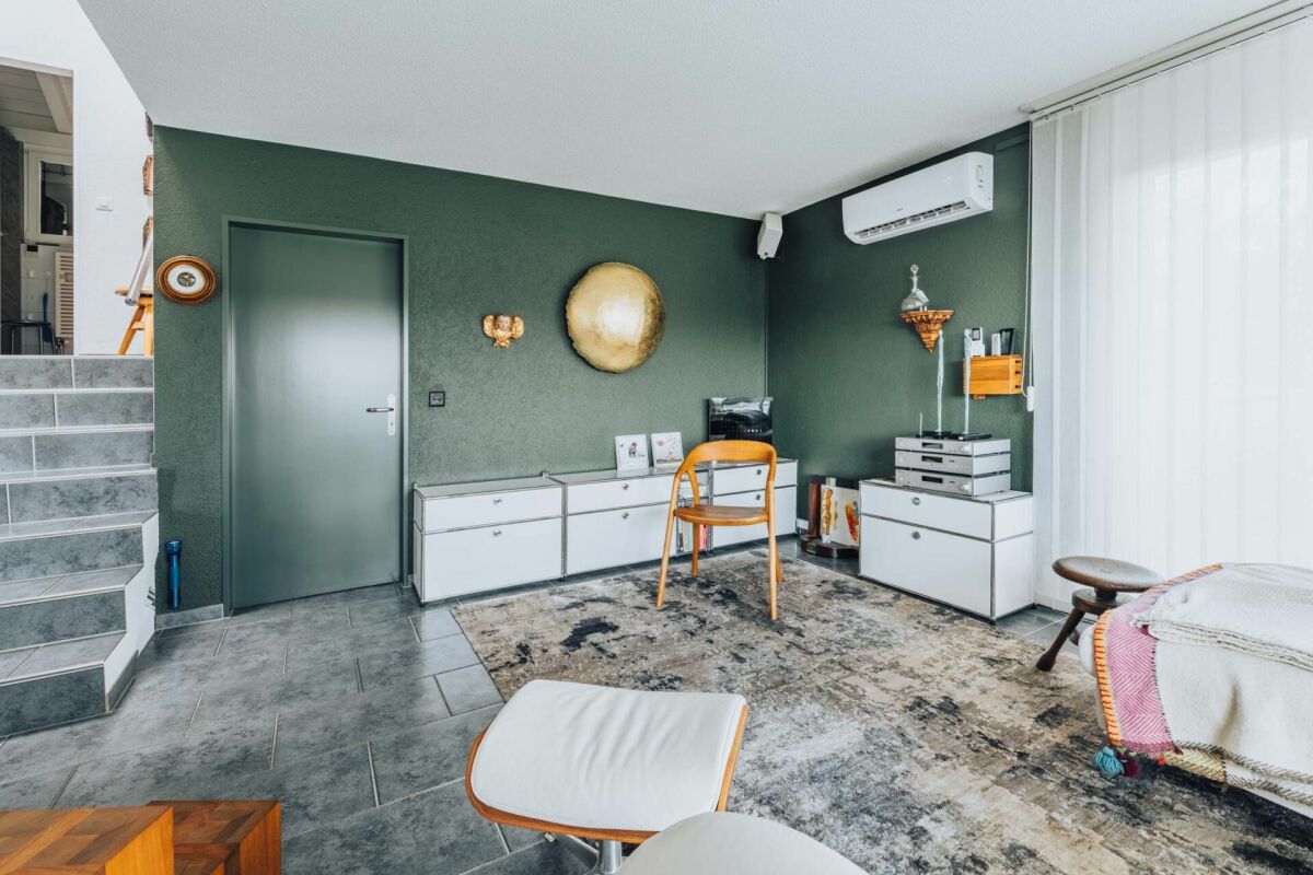 Modernes Wohn- oder Arbeitszimmer mit Treppe und Klimagerät
