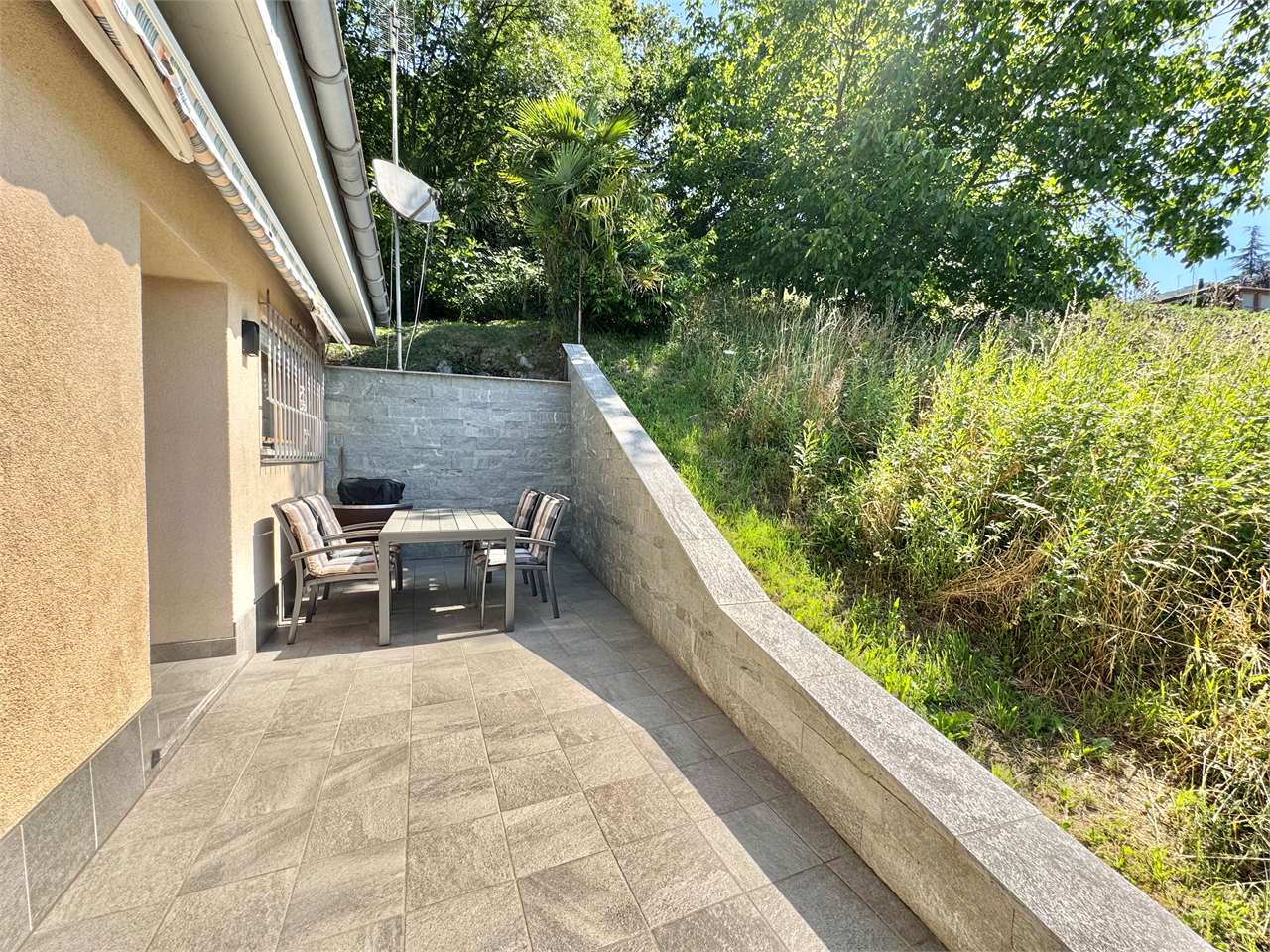Terrasse mit Sitzgruppe neben dem Haus