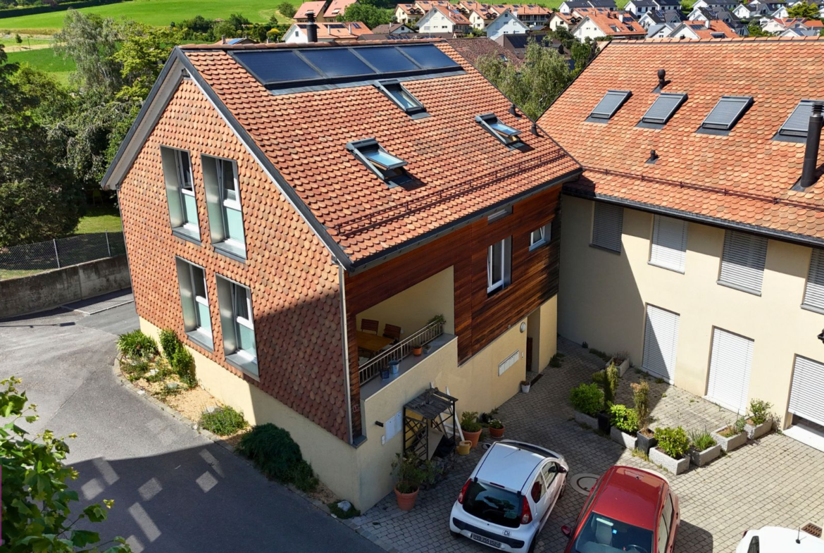 Außenansicht eines Wohnhauses mit Ziegeldach und Innenhof