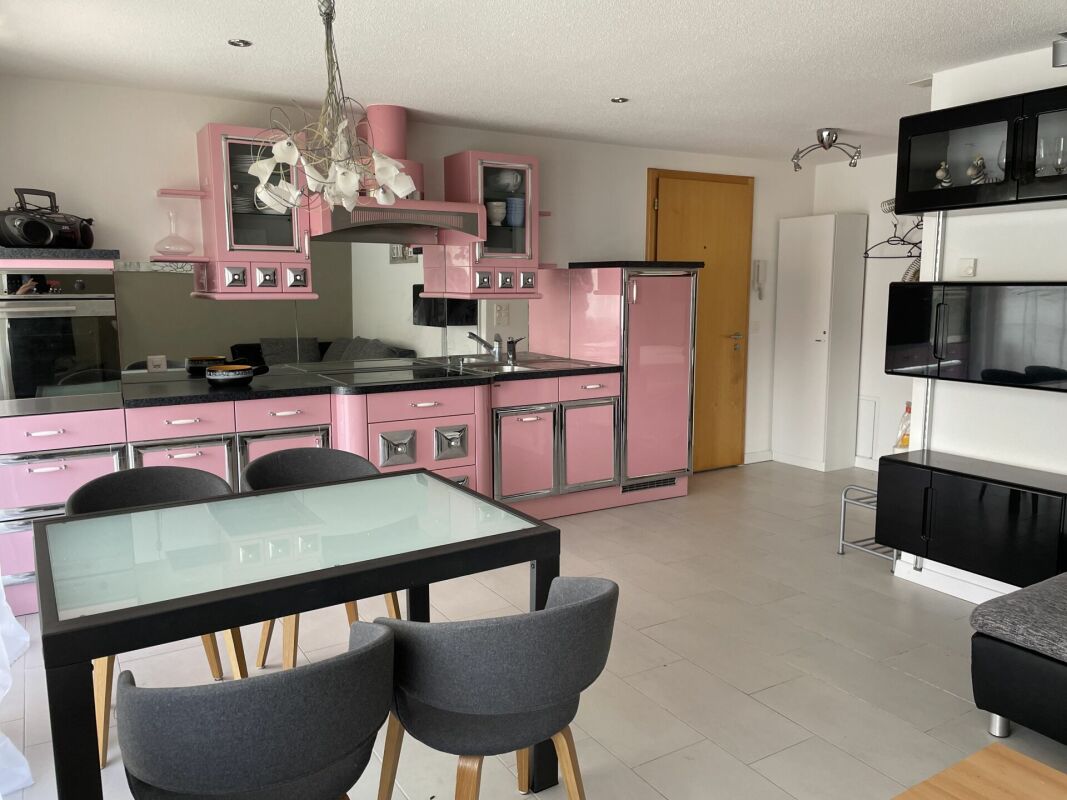 Küche mit Essbereich in Rosa und Schwarz