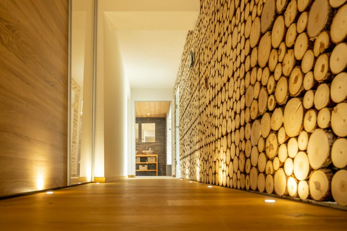 Holzverkleideter Flur mit Akzentwand aus Holzscheiben