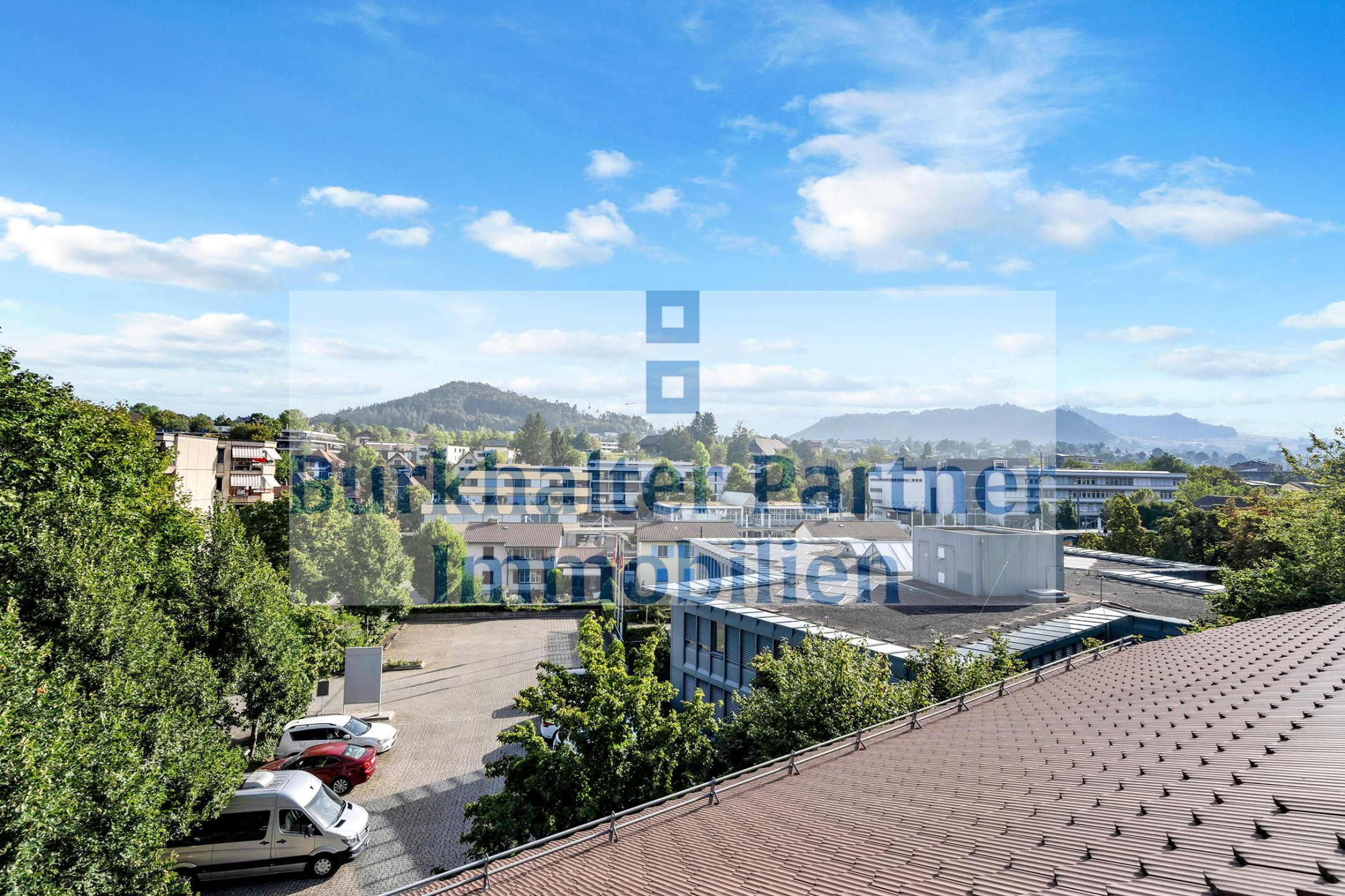 Städtischer Fernblick mit Bergen und Wasserzeichen