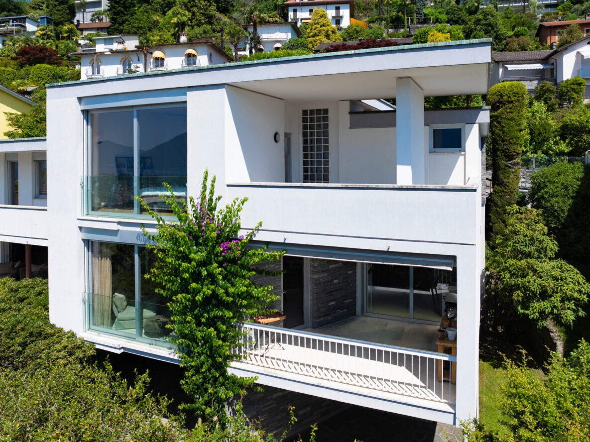 Moderne weiße Villa mit Balkon und großem Fenster