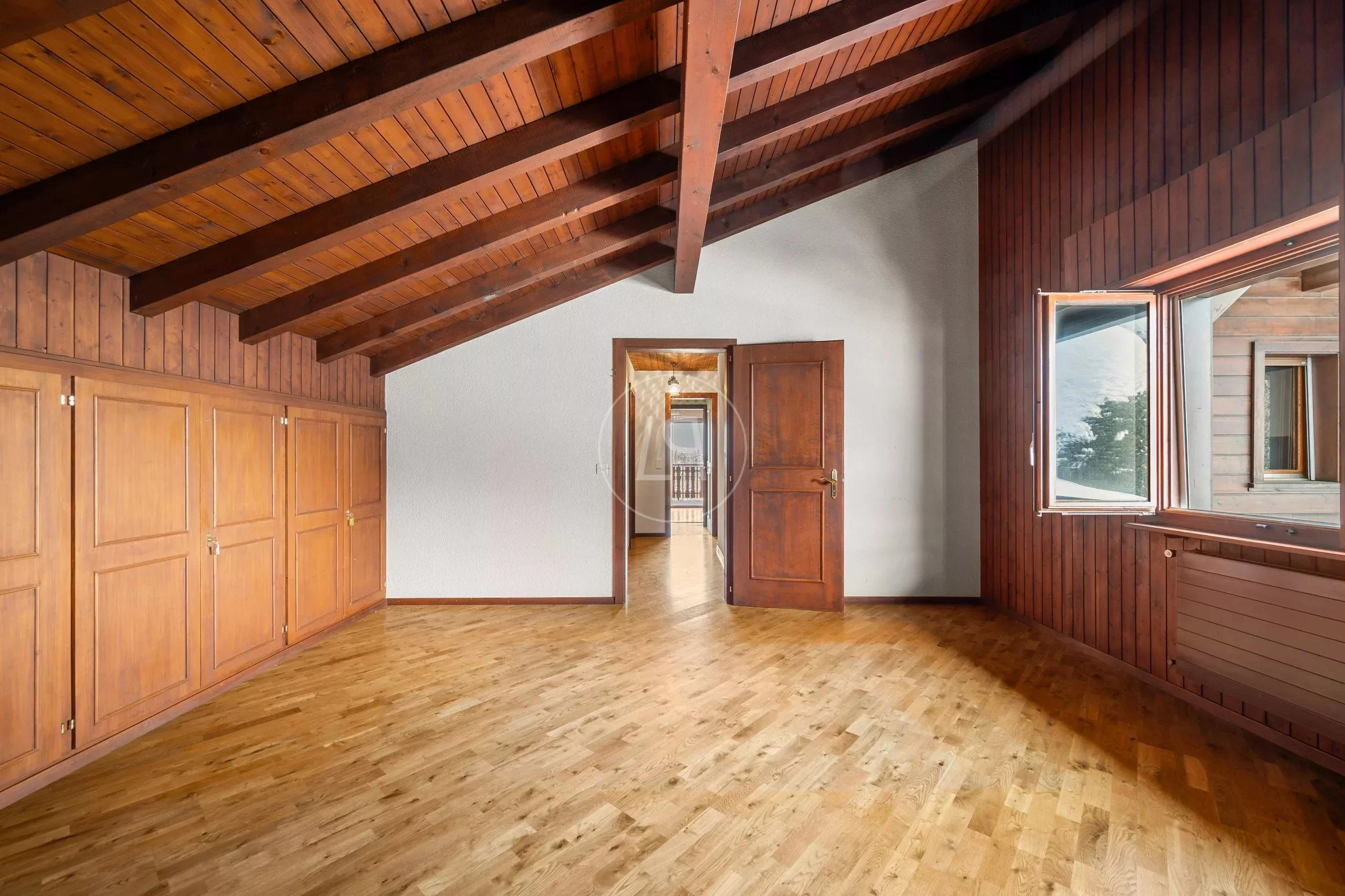 Großer leerer Dachraum mit Holzdecke und Einbauschränken