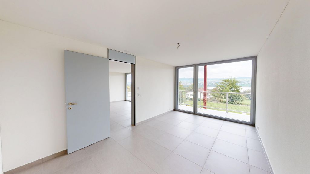 Helles, leeres Zimmer mit Balkonblick