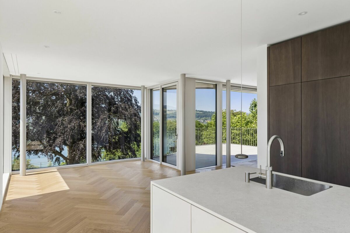 Offener Wohnbereich mit Panoramafenstern und Kücheninsel