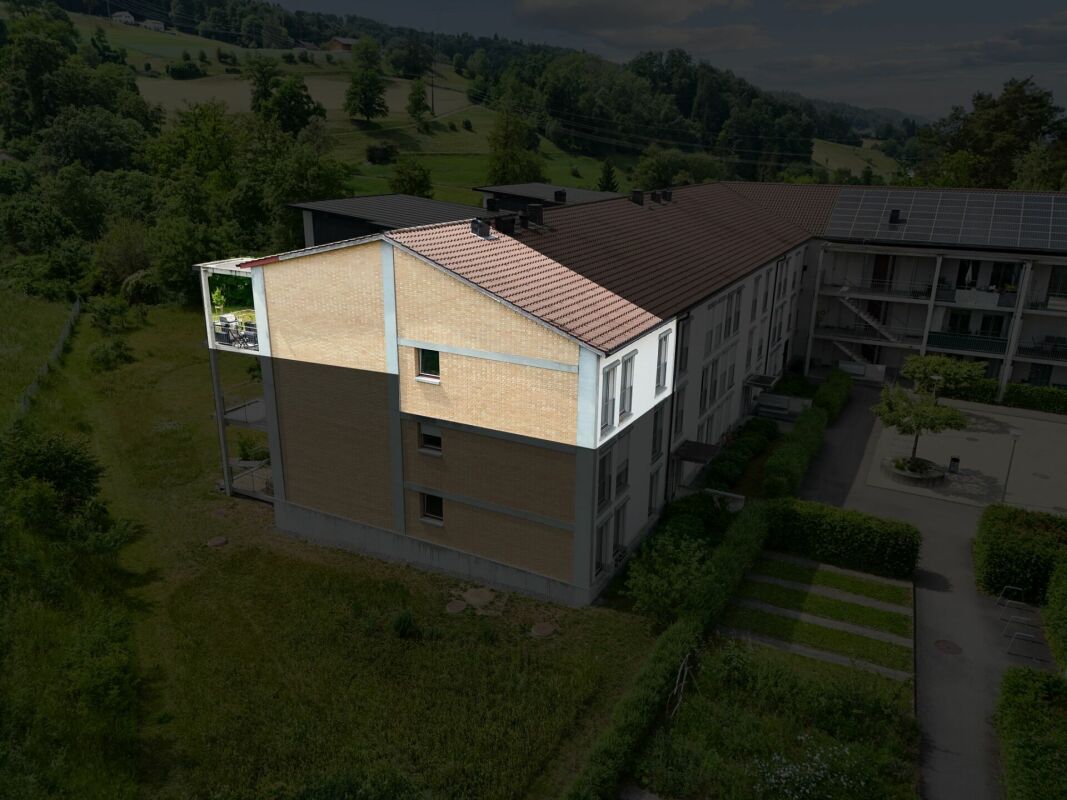 Wohnanlage mit Satteldach und Photovoltaik aus der Luft