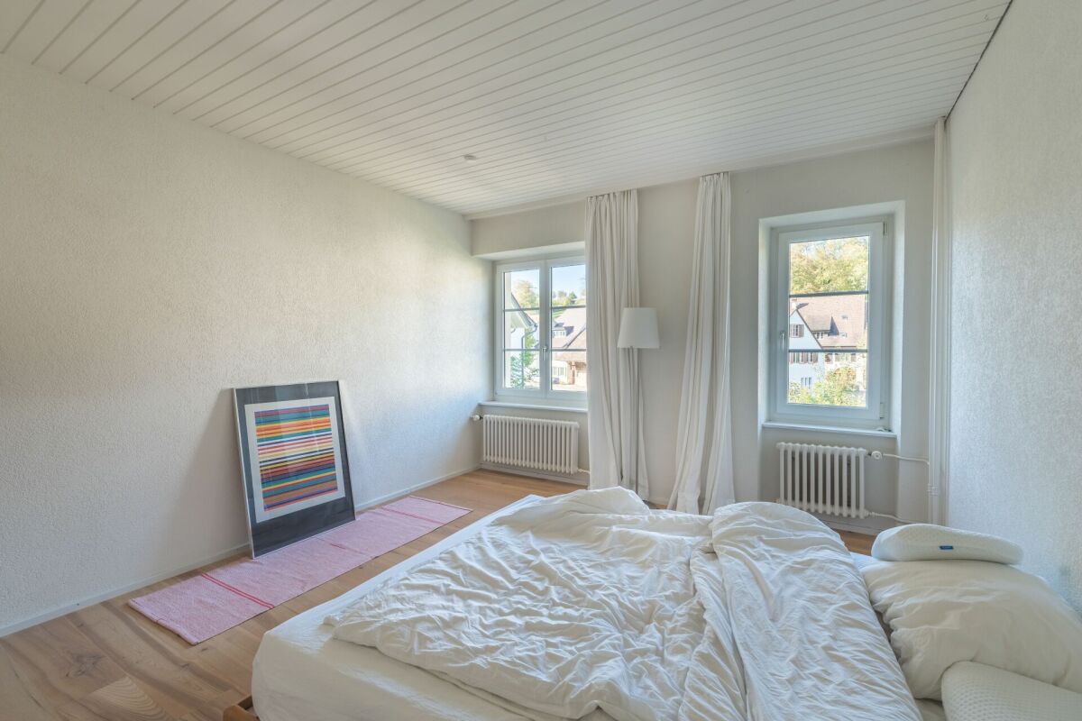 Helles Schlafzimmer mit zwei Fenstern