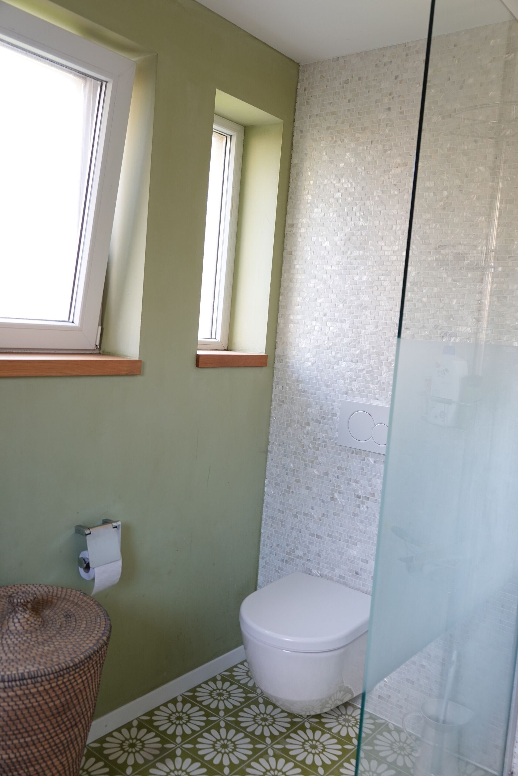 Gäste-WC mit grünem Wandton und weißer Sanitärkeramik