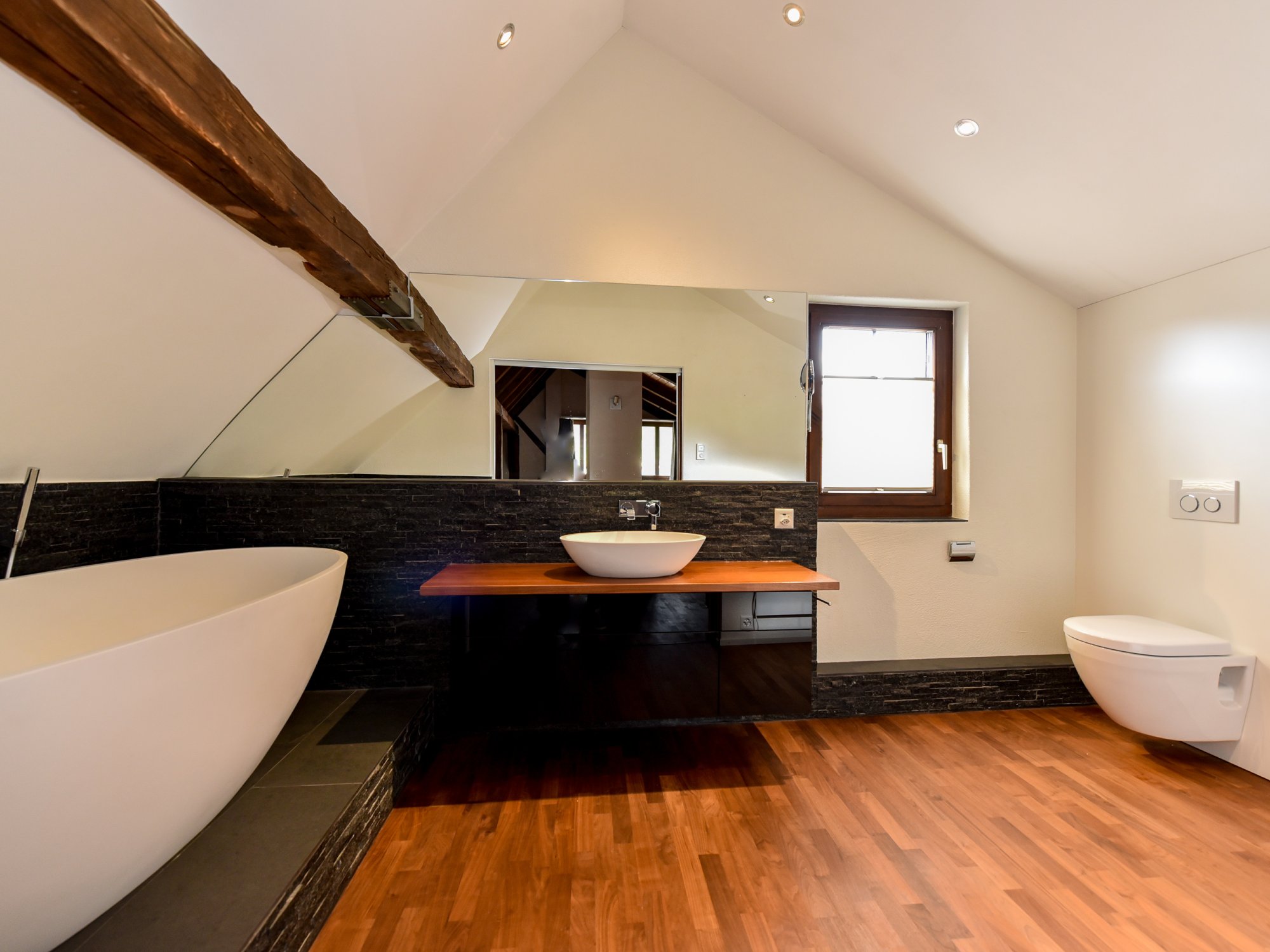 Luxuriöses Bad mit freistehender Wanne und Dachschräge