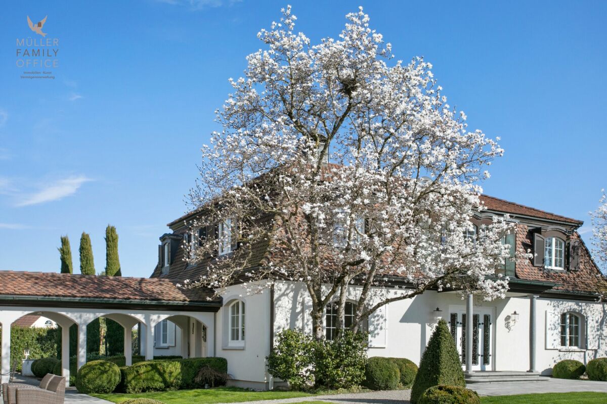Exklusives Landhaus mit blühendem Baum
