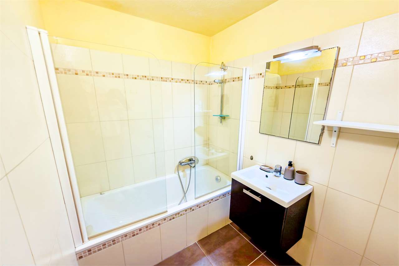 Helles Badezimmer mit Wanne und Waschtisch