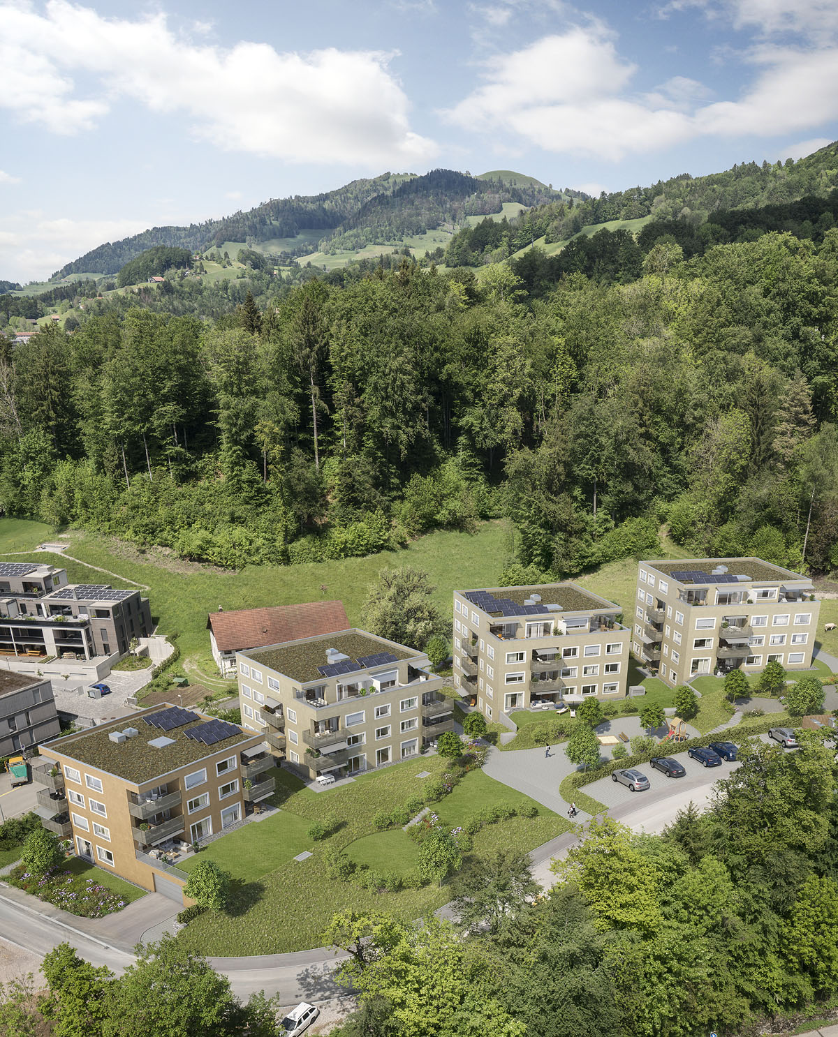 Luftaufnahme einer Wohnsiedlung in grüner Hanglage