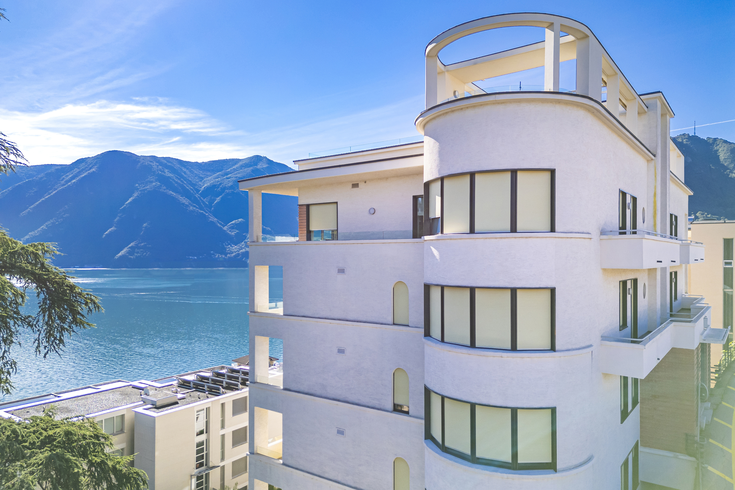 Moderne Wohnanlage am See mit Bergpanorama