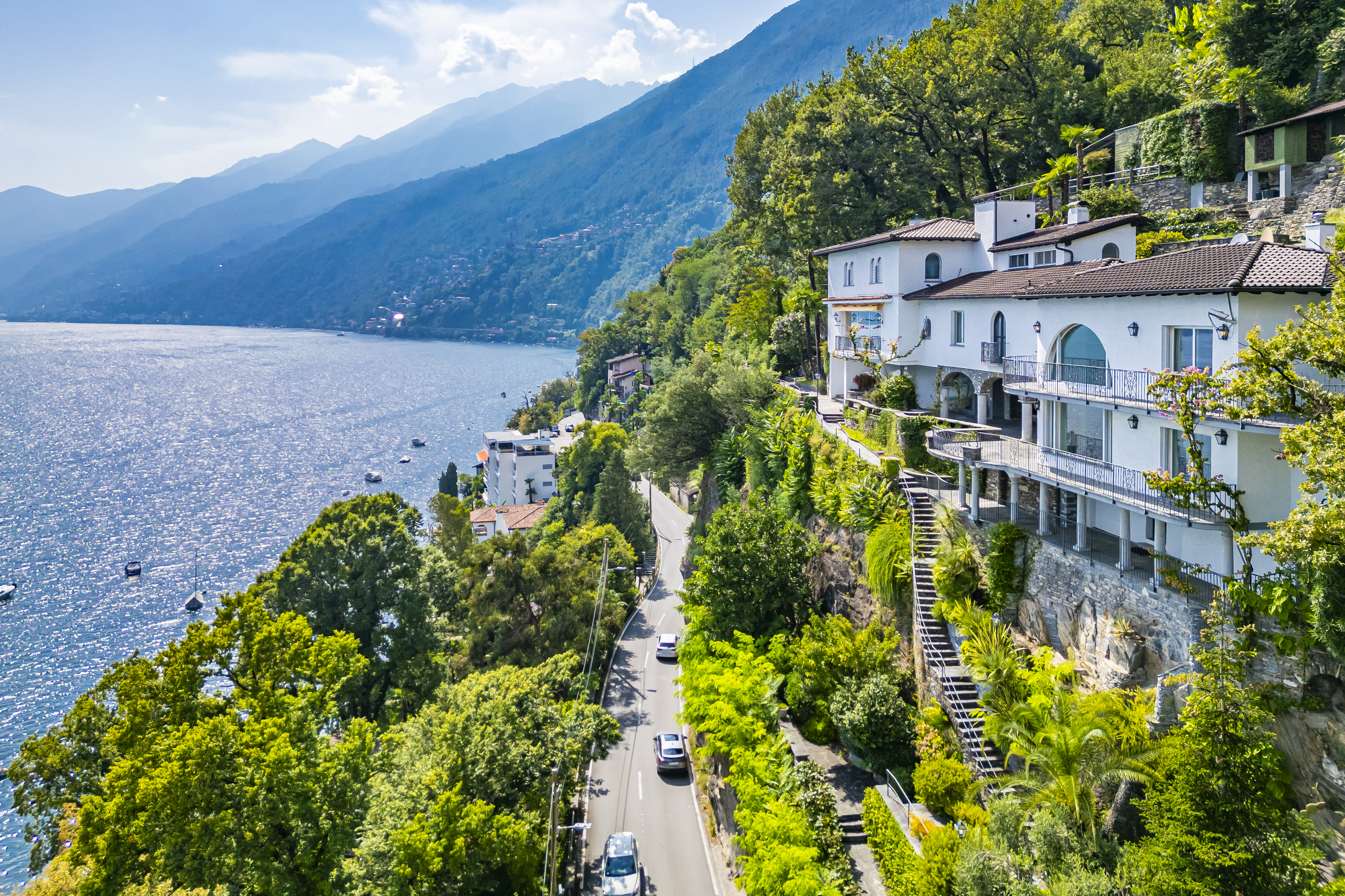 Seeblick auf eine mediterrane Villa an steiler Hanglage