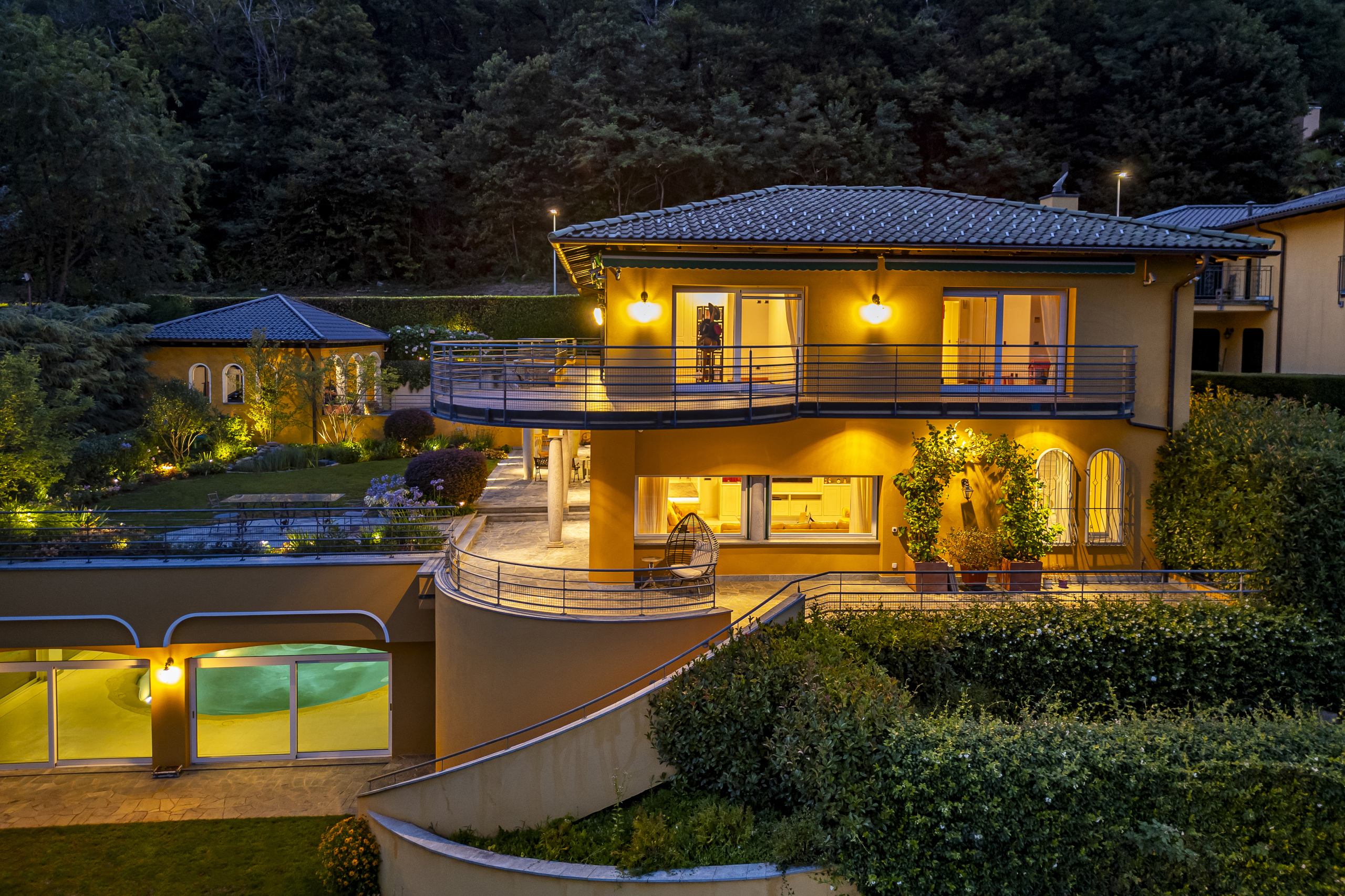 Abendliche Außenansicht einer mediterranen Villa mit Garten
