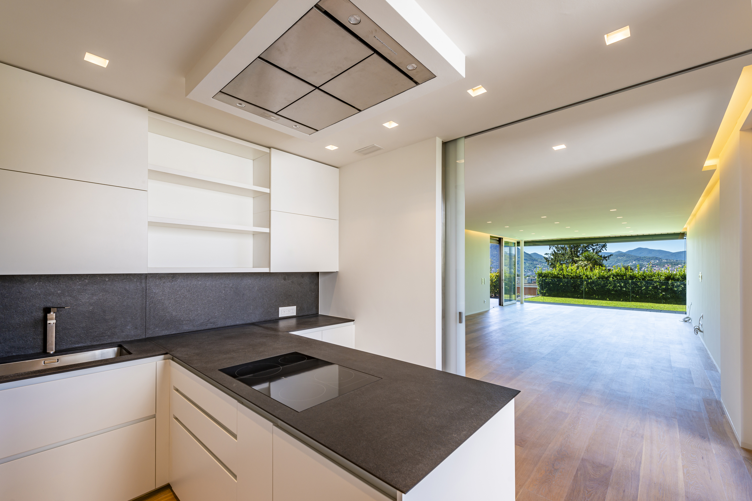 Moderne Küche mit Blick ins Wohnzimmer und in den Garten