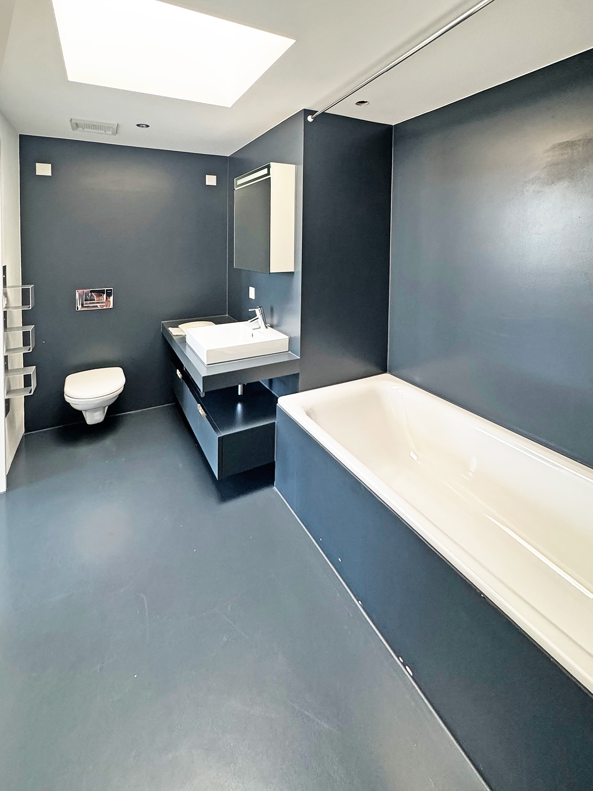 Modernes Badezimmer mit dunklen Wänden und Badewanne