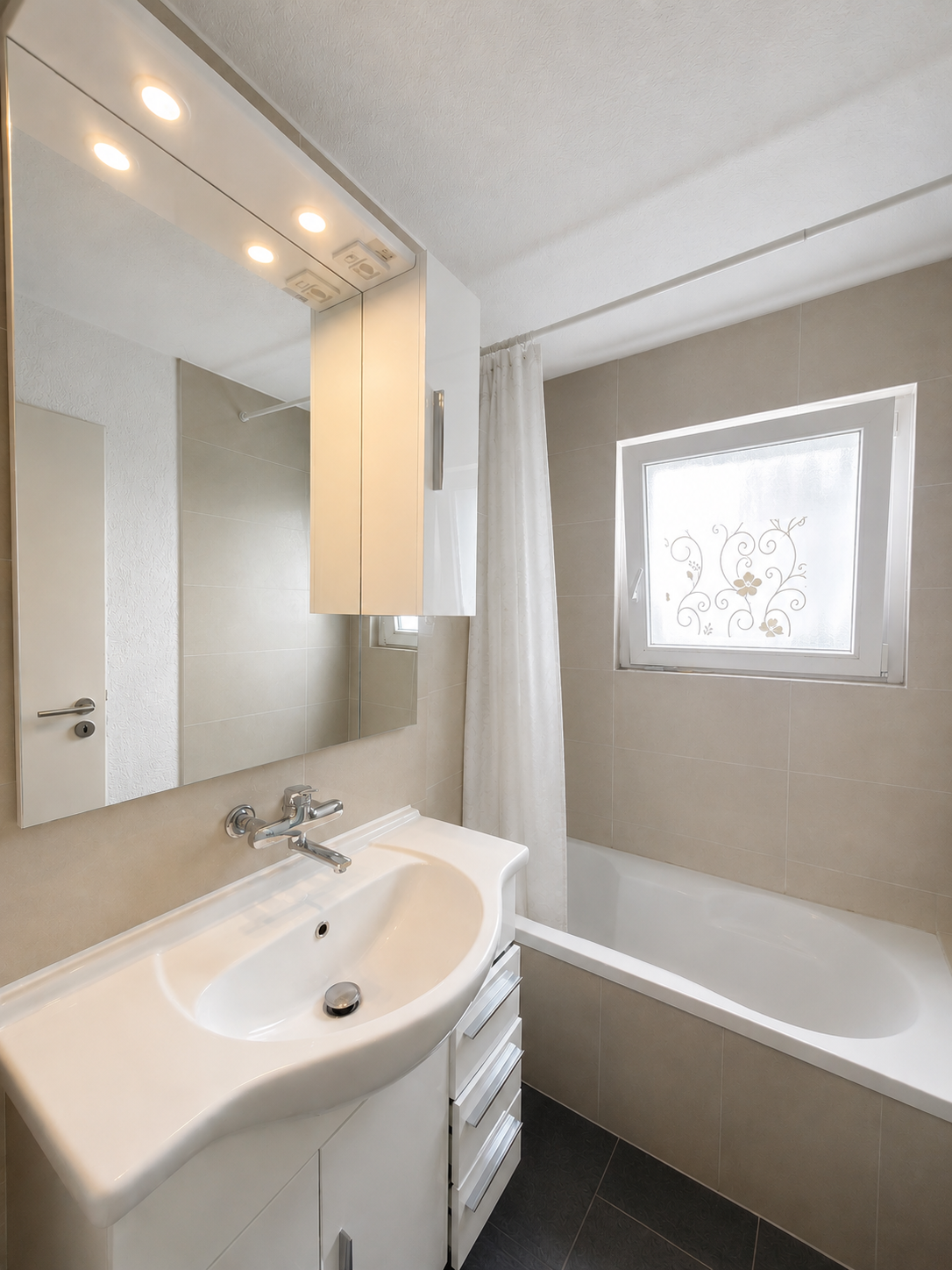 Helles Badezimmer mit Badewanne und Waschtisch